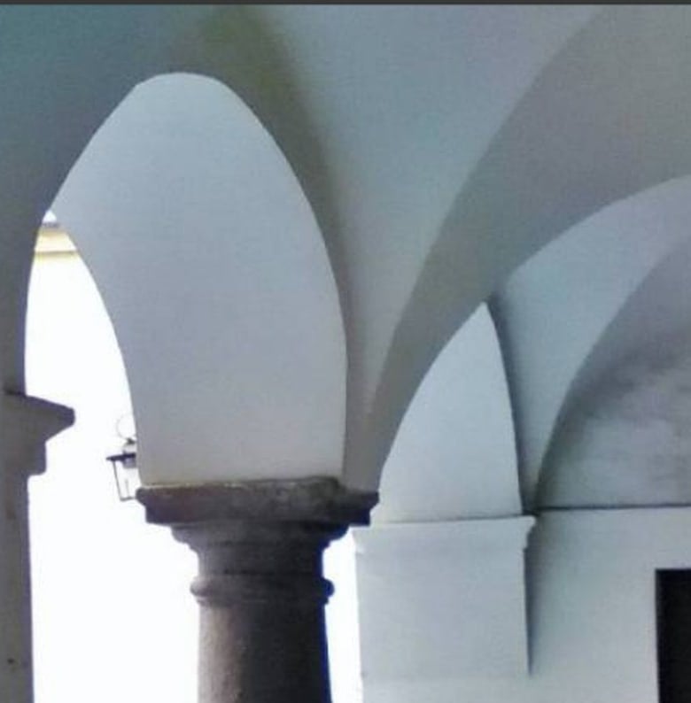 Il portico d'ingresso dell'edificio in Via del Carmine, con colonne in pietra e volte a crociera